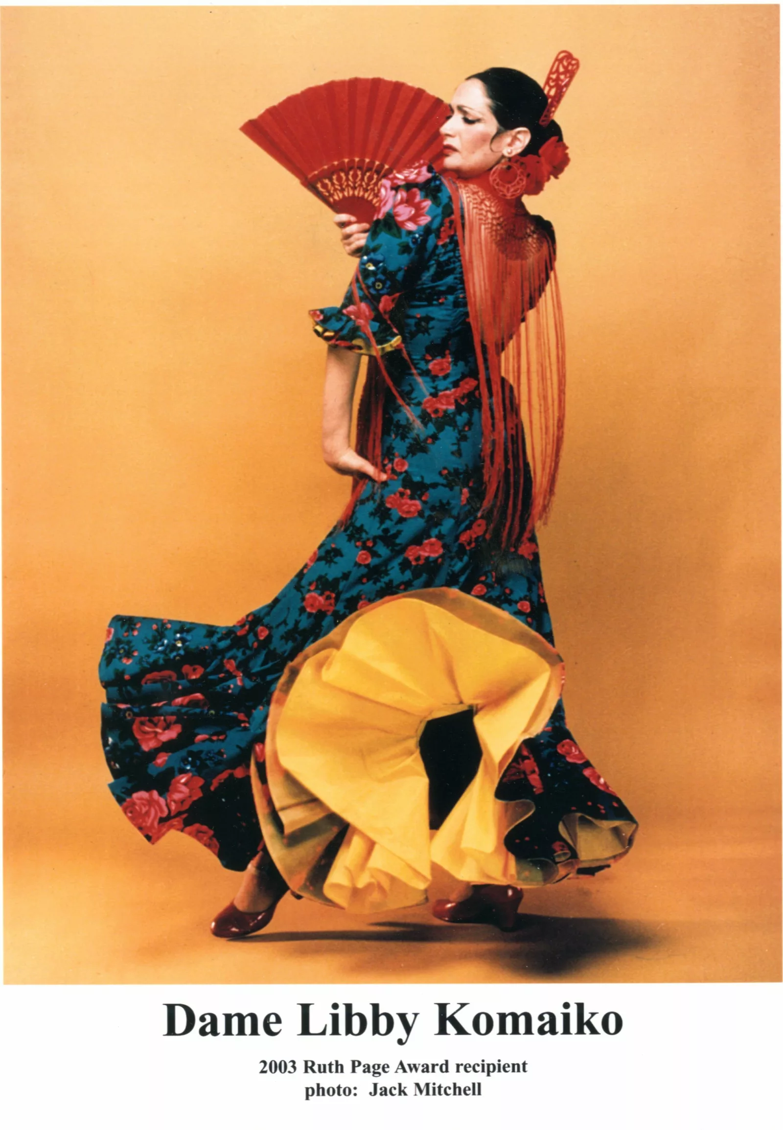 Dame Libby Komaiko poses in brightly colored flamenco dress.