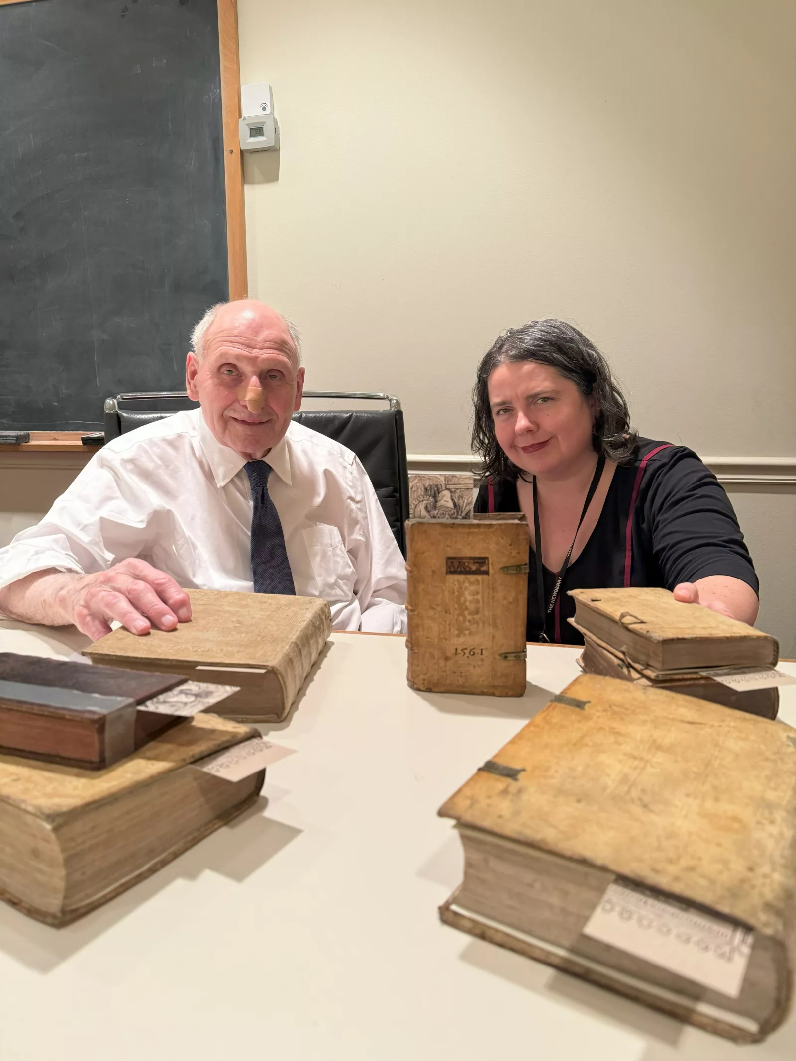 Newberry Curator Suzanne Karr Schmidt and Marvin Rawski pose in a conference room with Rawski's lost books.